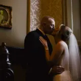 Couple kissing in stairwell of Lynnhurst