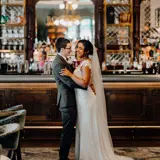 married couple on wedding day inside ornate bar at boclair house