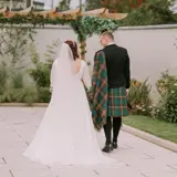 Couple walking away from camera holding hands