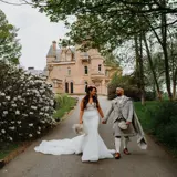 Married couple walking away from castle