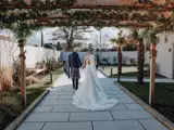 Married couple walking in the garden of The Garden House
