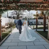 Married couple walking in the garden of The Garden House