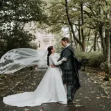 Couple standing in road in front of castle