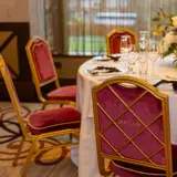 Seats and tables set for dinner at a wedding at Boclair House Hotel
