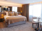 Bedroom with bed and tables and chairs