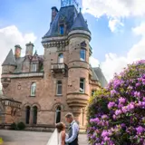 Bride and Groom standing infront of Cornhill Castle