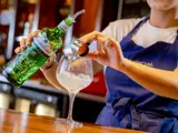 Gin being poured at bar