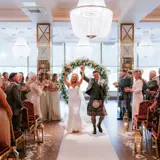 newly married couple walking down aisle in boclair wedding venue hall