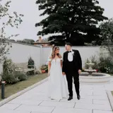 Couple walking infront of fountain
