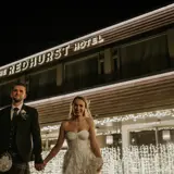 Couple standing outside The Redhurst Hotel