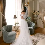 Bride posing with flowers in Honeymoon Suite