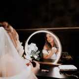 Bride getting ready in a mirror