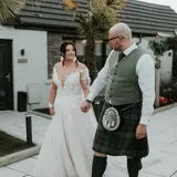 Couple walking through garden holding hands