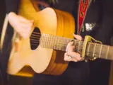 Person playing guitar at an event