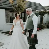 Couple holding hands and looking at each other int he garden