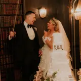 Couple behind wedding cake