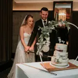 Couple getting ready to cut their cake