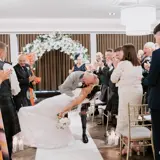 Groom kissing bride in the middle of the aisle