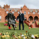 married gay couple on the boclair grounds after wedding ceremony