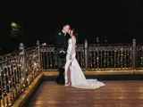 Bride and groom celebrating their evening reception on the illuminated fairy-lit balcony at The Busby Hotel in Glasgow Southside