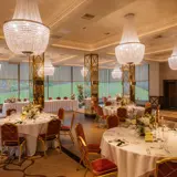 wedding ceremony hall arrangement with guest tables and top table