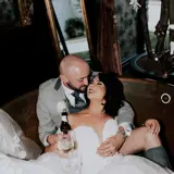 Bride and groom in hot tub in honeymoon suite