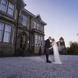 Couple kissing outside of Lynnhurst at sunset
