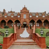 Bride posing on the stairs in front of Boclair House Hotel