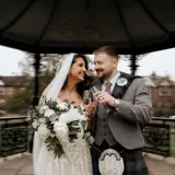 married couple in boclair house gardens toasting champagne