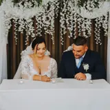 Couple signing their marriage certificate