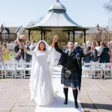 married couple celebrating after vows in boclair wedding venue gardens