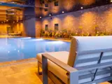 chair by a lit up pool in bowfield luxury spa in scotland