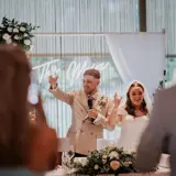 Couple raising a glass at their wedding