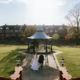 Ariel shot of couple walking to Bandstand