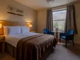 double bed inside tarbet hotel in loch lomond