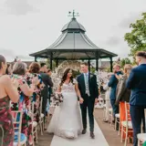 Couple walking away from the alter at a ceremony outside