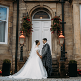 Couple posing outside of Lynnhurst front door
