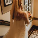 Bride on stairwell holding flowers
