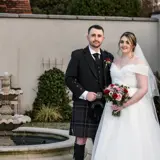Couple standing next to fountain
