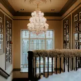 ornate hallway and banister with wedding floral arrangement