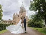 Couple kissing with Castle in the background