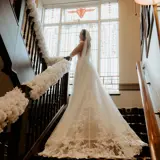 Bride posing on the stairs of Boclair House Hotel
