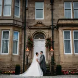Couple posing outside of Lynnhurst front door