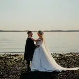 married couple on beach enjoying midweek wedding package