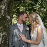 Couple under a tree looking lovingly at each other