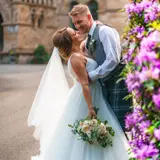 Couple kissing next to flowers