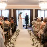 Couple holding hands at the alter