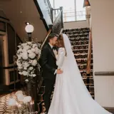 Couple kissing at the bottom of the stairs